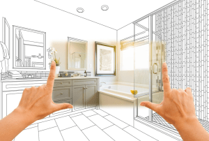 Hands framing a modern bathroom design concept with a shower, bathtub, and stylish tile work, illustrating remodeling ideas for enhancing space and functionality.