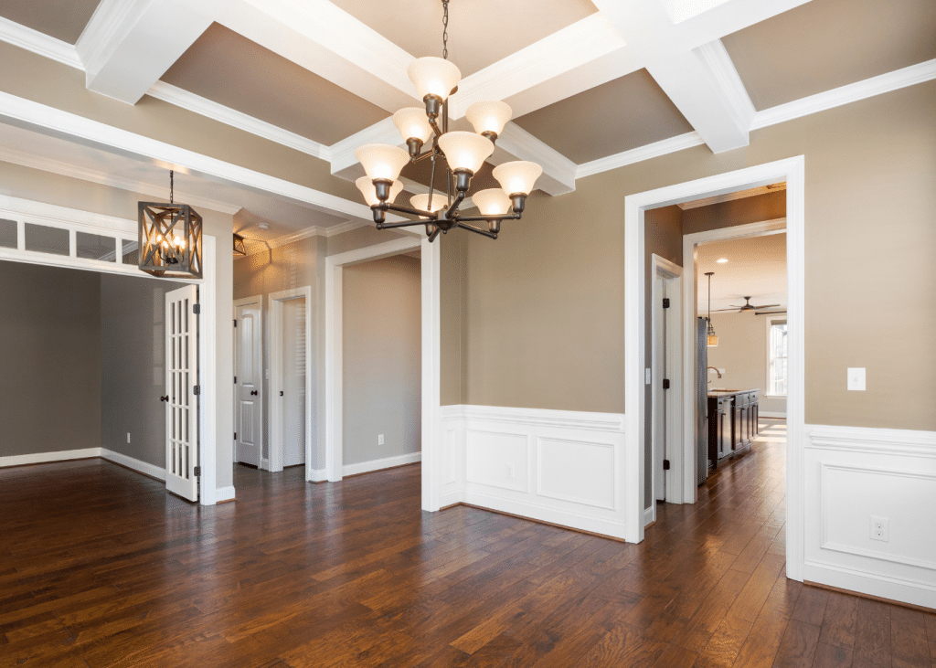 Elegant interior space showcasing hardwood flooring, coffered ceiling, and stylish lighting fixtures, representing NW Tile & Flooring's expertise in high-end flooring installation in Keizer, Oregon.