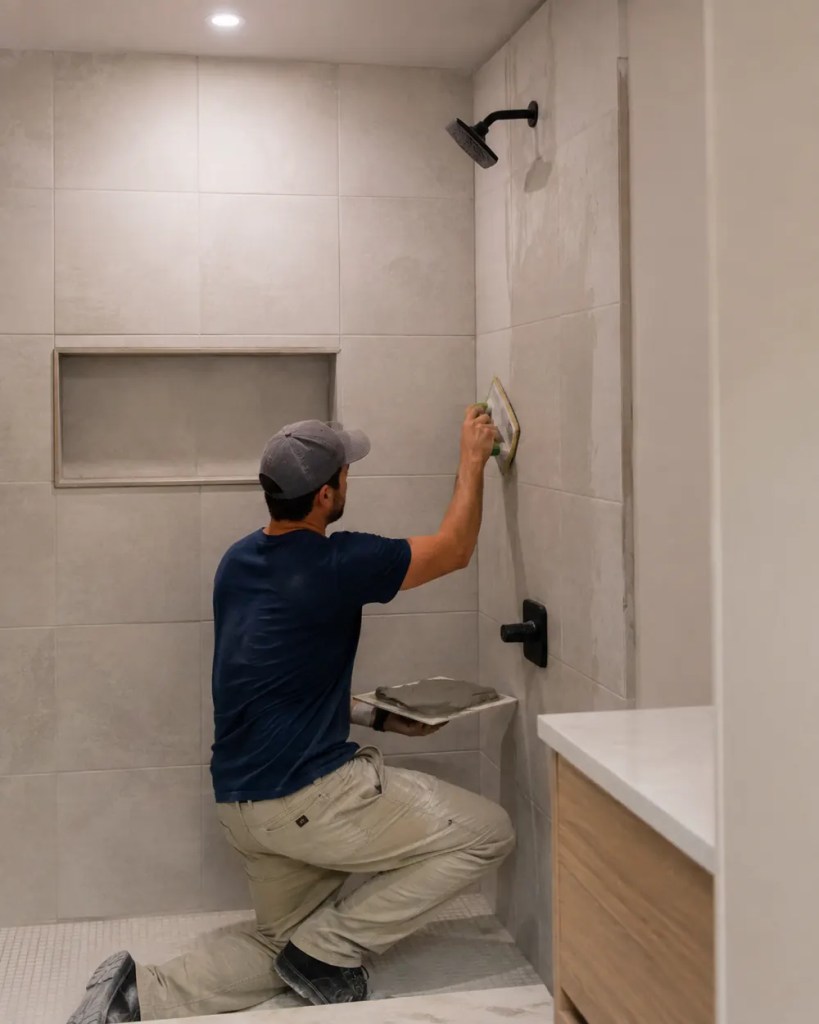 Bathroom Remodel in Albany - OR in progress as a crew installs a new vanity and wall tile