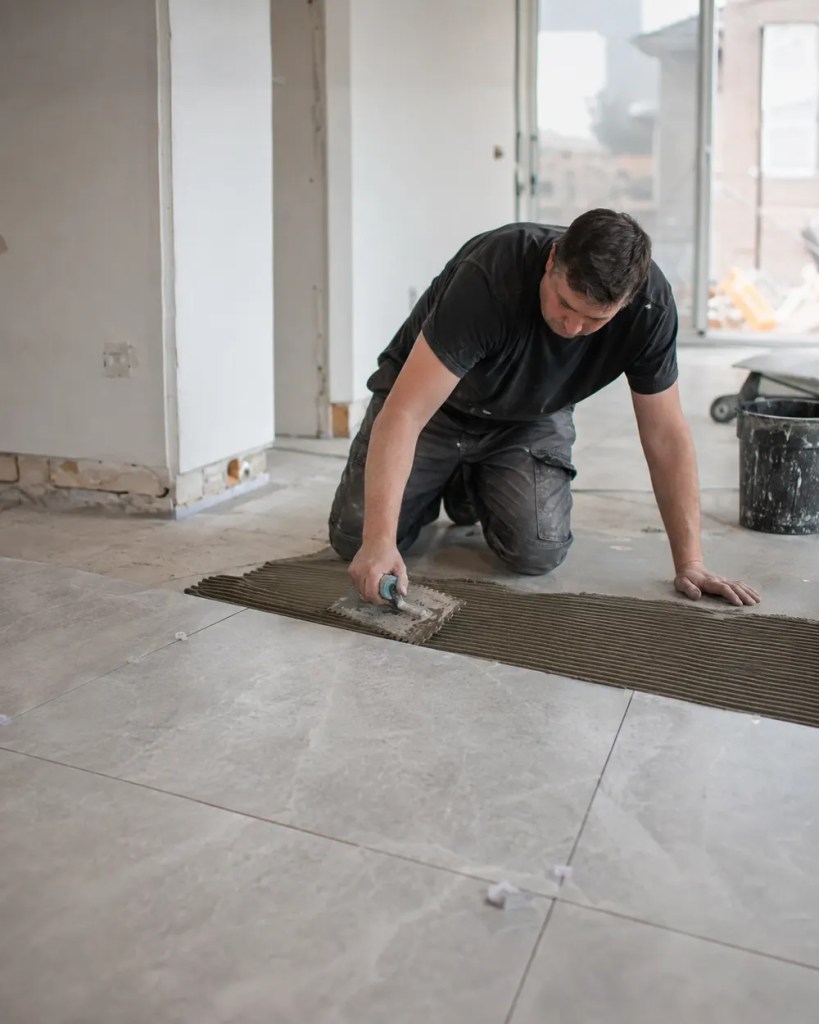 Tile Contractor in Keizer - OR aligning large-format floor tile in a remodeled kitchen,Tile Contractor in Corvallis - OR measuring a kitchen backsplash layout before setting ceramic tile, Tile contractor in Eugene, OR aligning large-format floor tile in a remodeled kitchen