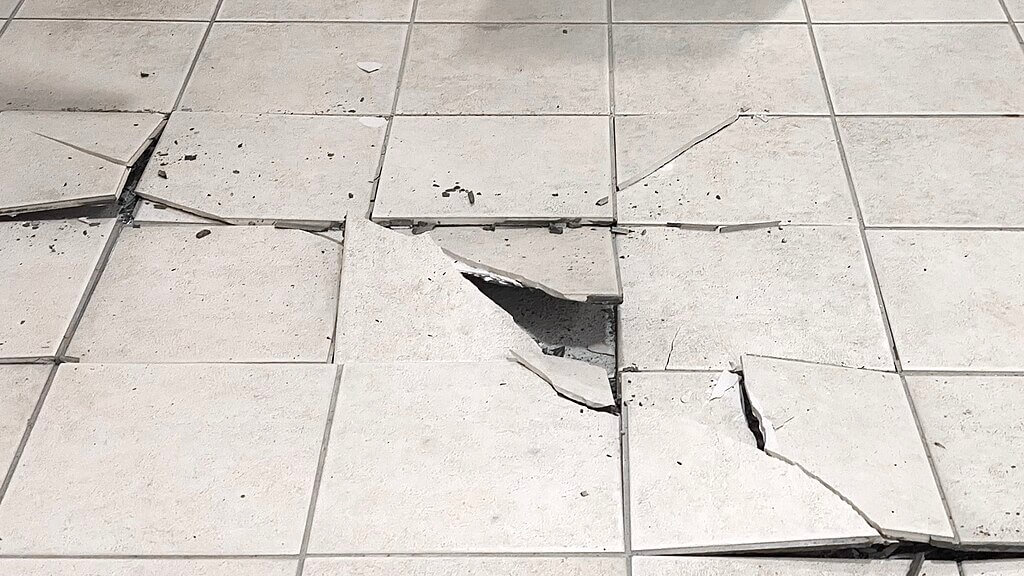 what causes floor tiles to crack